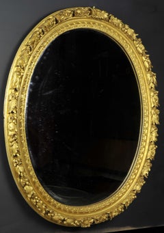 Oval Mirror in a Carved and Gilded Wood Frame from the 18th Century