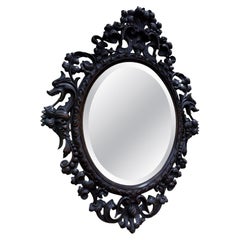 Specchio ovale in legno intagliato con teste di drago