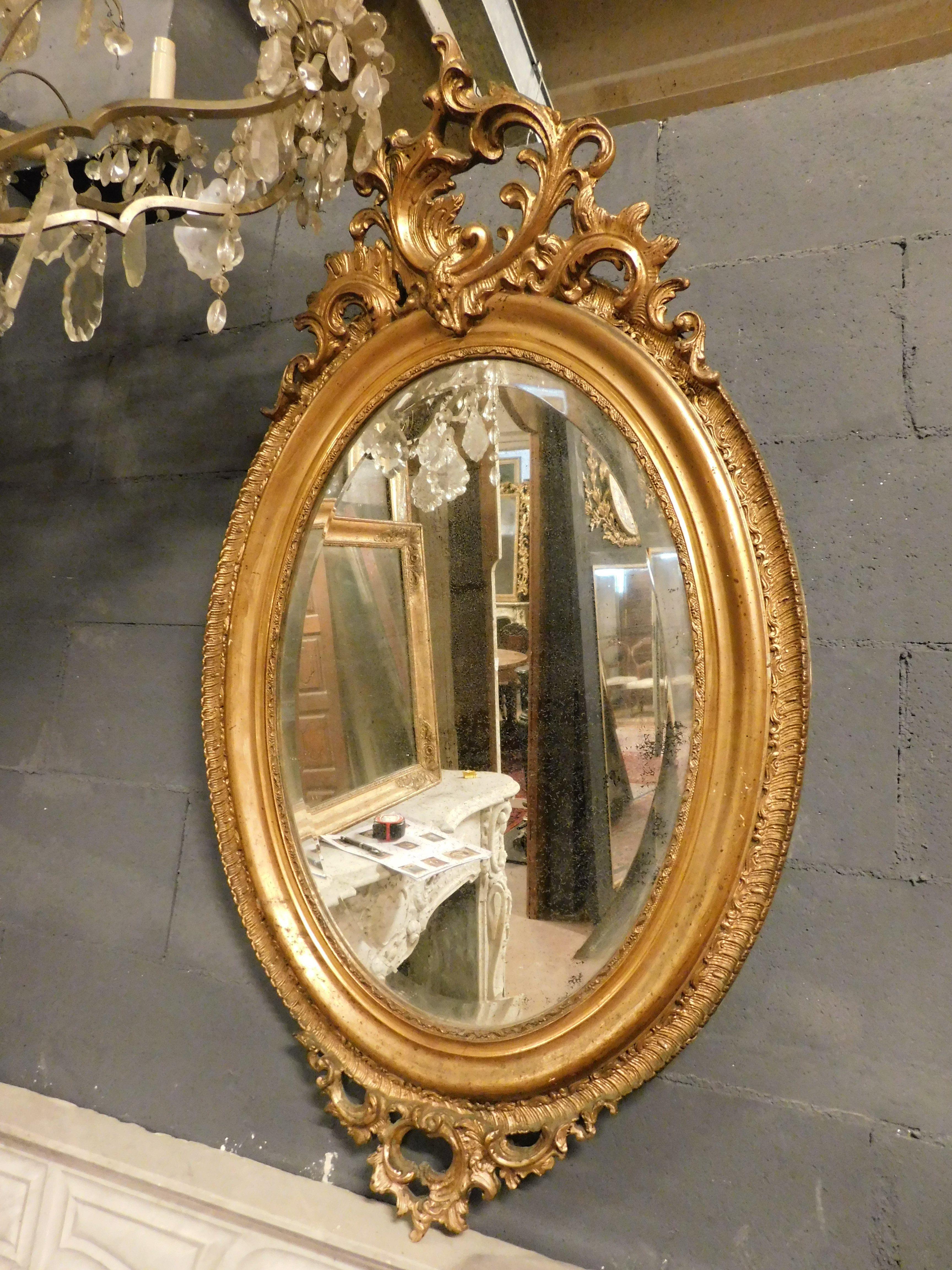 Antique oval mirror in gilded wood with carved cymatium, from France from the 19th century, maximum size W 62 x H 110 cm