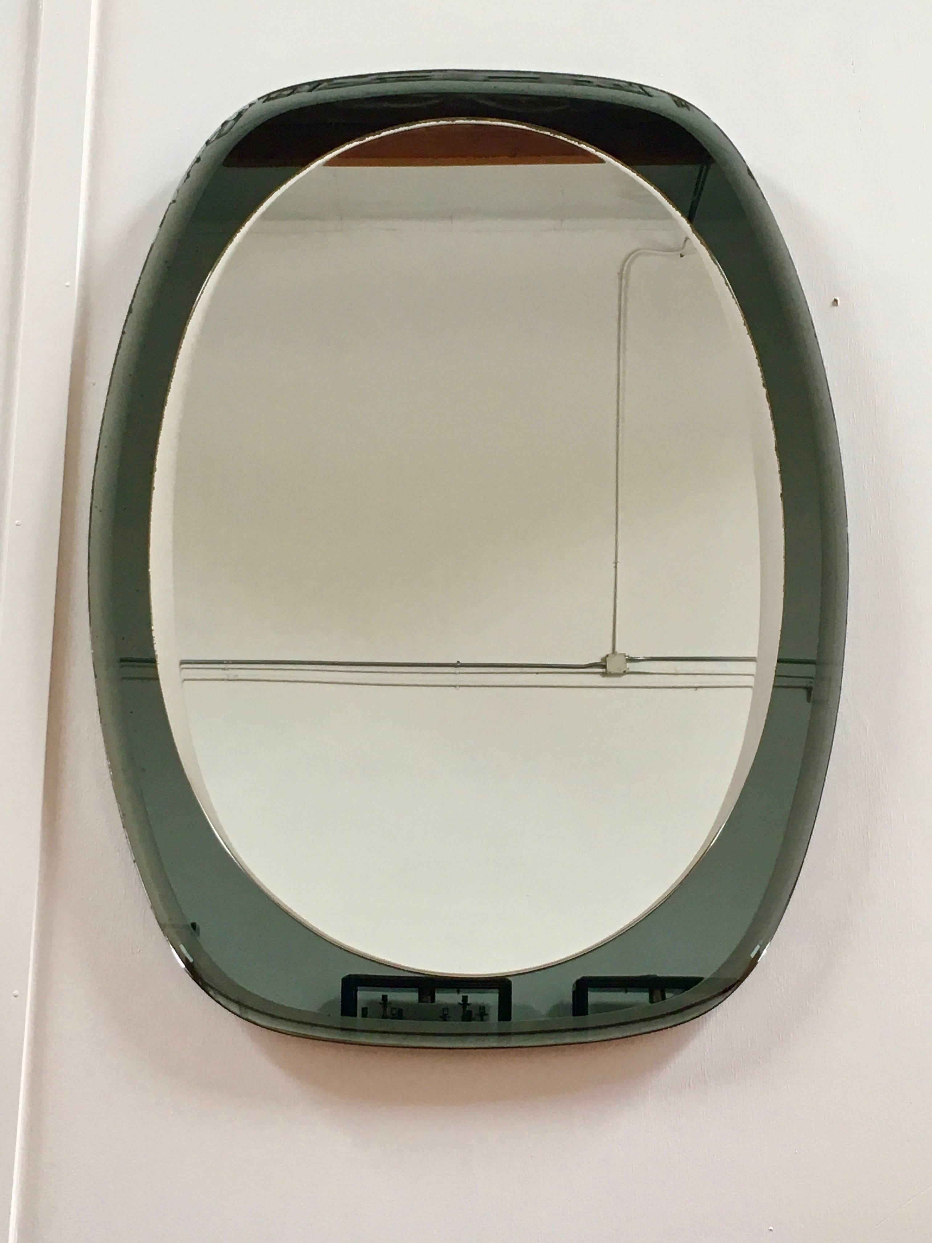 Oval smoked bevelled mirror topped with a bright bevelled mirror in the Italian style.