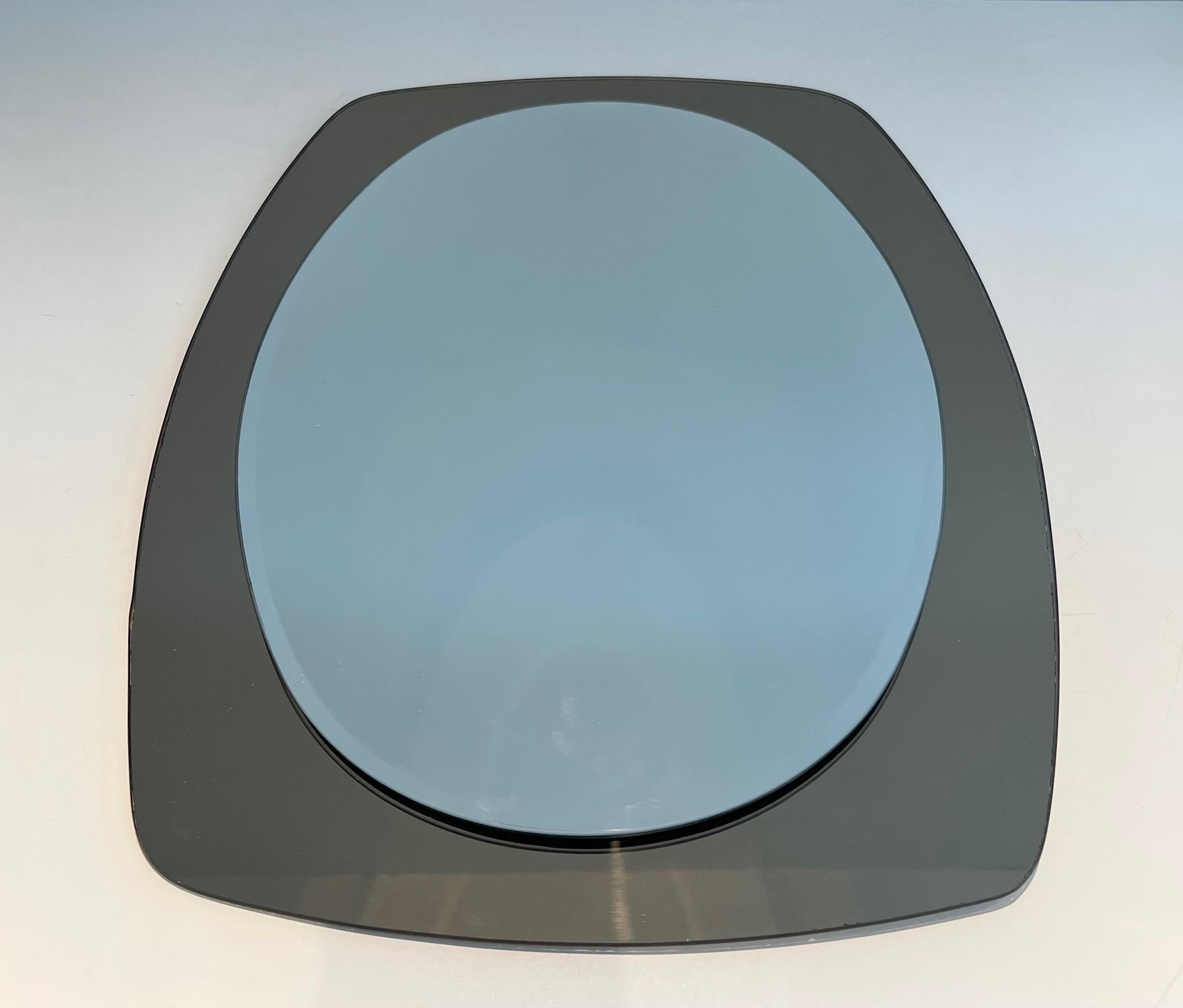 This oval mirror is made of a clear mirror on the center, surrounded by a bronze mirror. This is an Italian work by Fontana Arte. Circa 1970