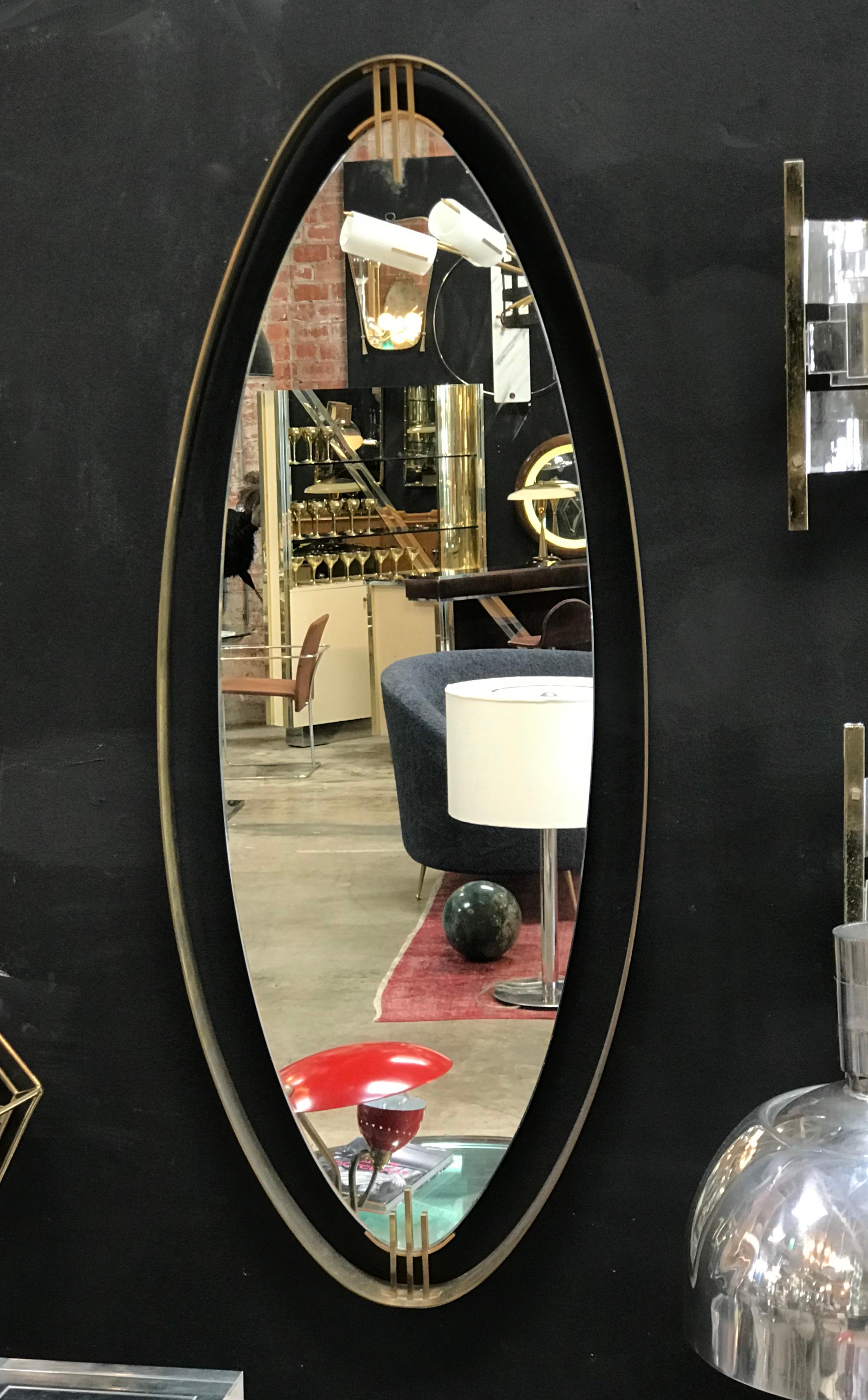 Oval mirror found in Italy features a dark iron, floating-style frame that accentuates the shape and height of this mirror, circa 1970s. Unknown maker.

Actual mirror measures: 37.5” high x 12.5” wide.