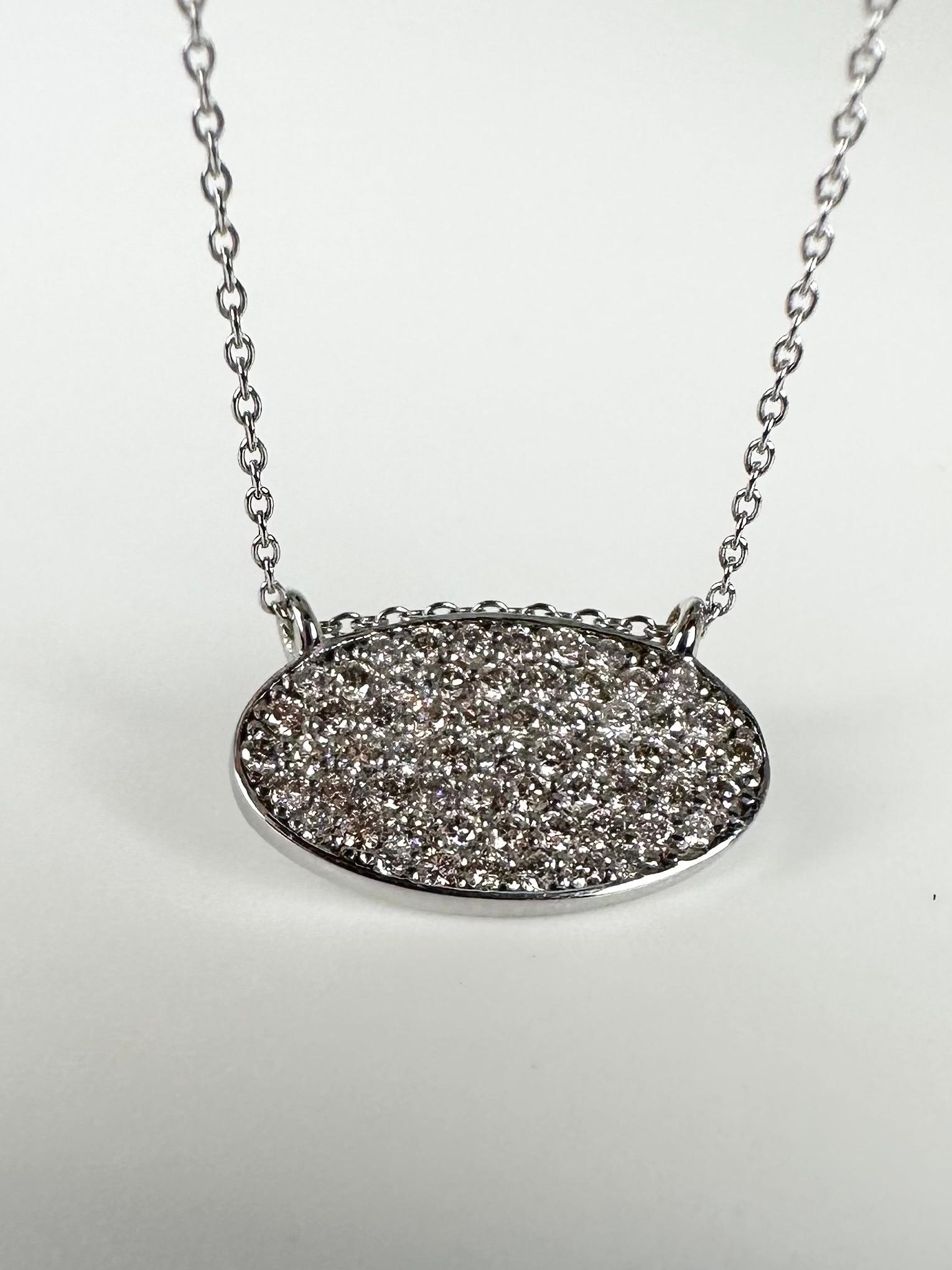 Modern oval pendant necklace in 14KT white gold, made as illusion to have maximum sparkle and very little gold between the diamonds, stunning pave set diamond pendant necklace. Chain is 18