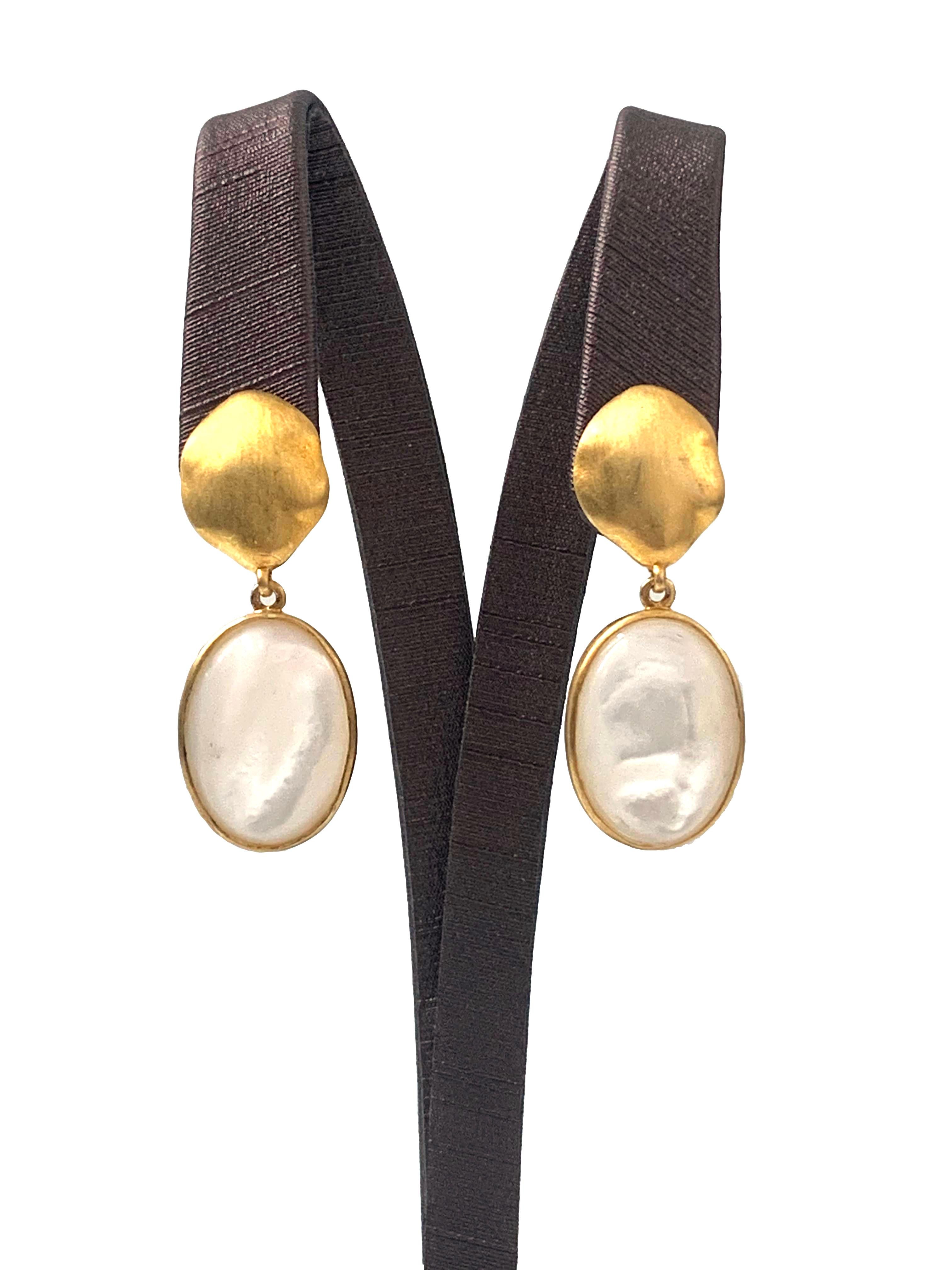 Discover oval Mother of Pearl vermeil drop earrings. The earrings feature 2 large oval-shape cabochon-cut Mother of Pearl with unique and beautiful luster, handcrafted brushed satin texturing technique, and hand set in vermeil 18k gold plated