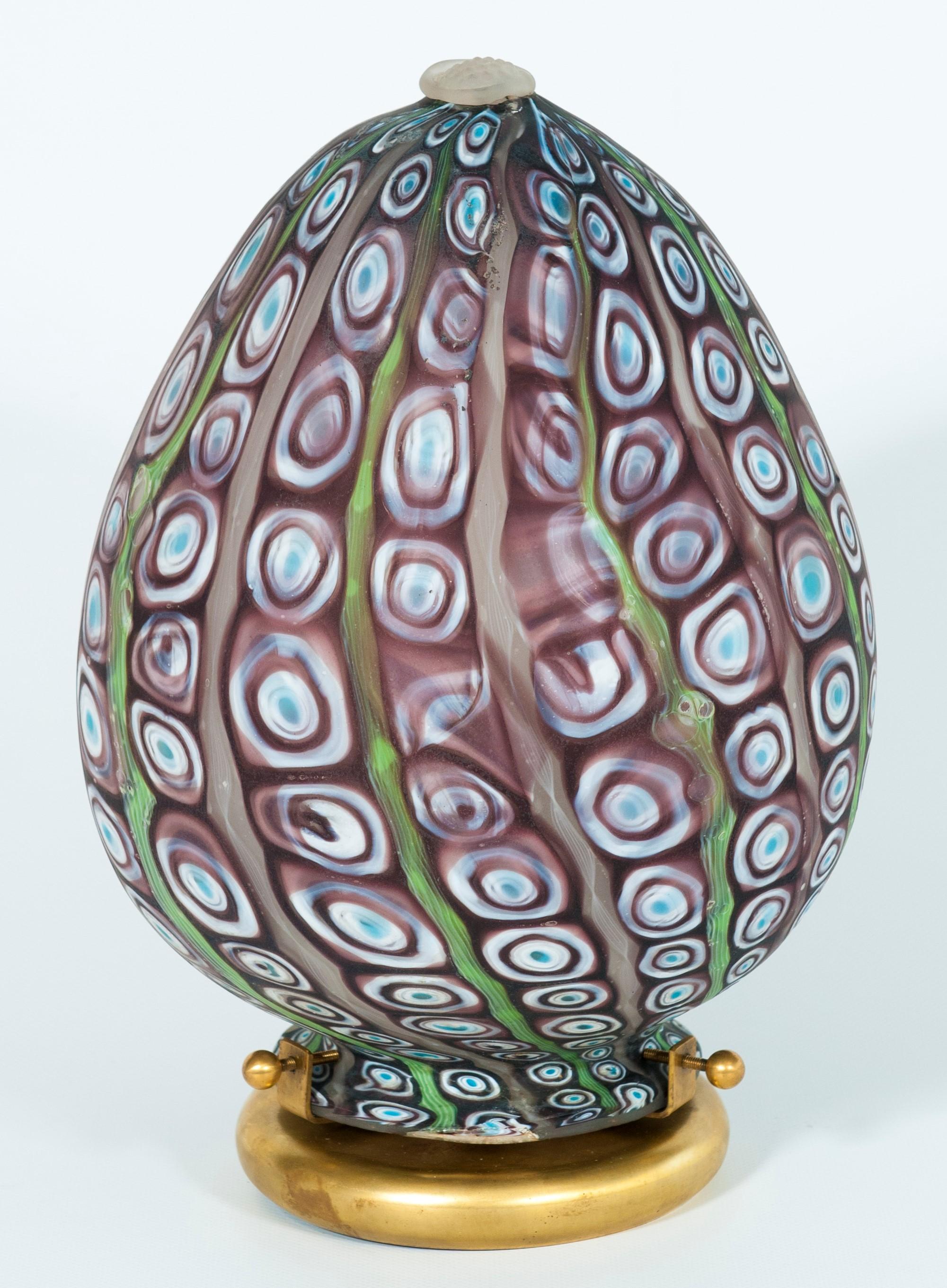 Oval Murano glass table lamp with colorful Venetian Murinas, Italy, 1980s
This extraordinary oval table lamp takes the external appearance of an egg, but its inner burst of light donates a totally new nature to this beautiful masterpiece, making it