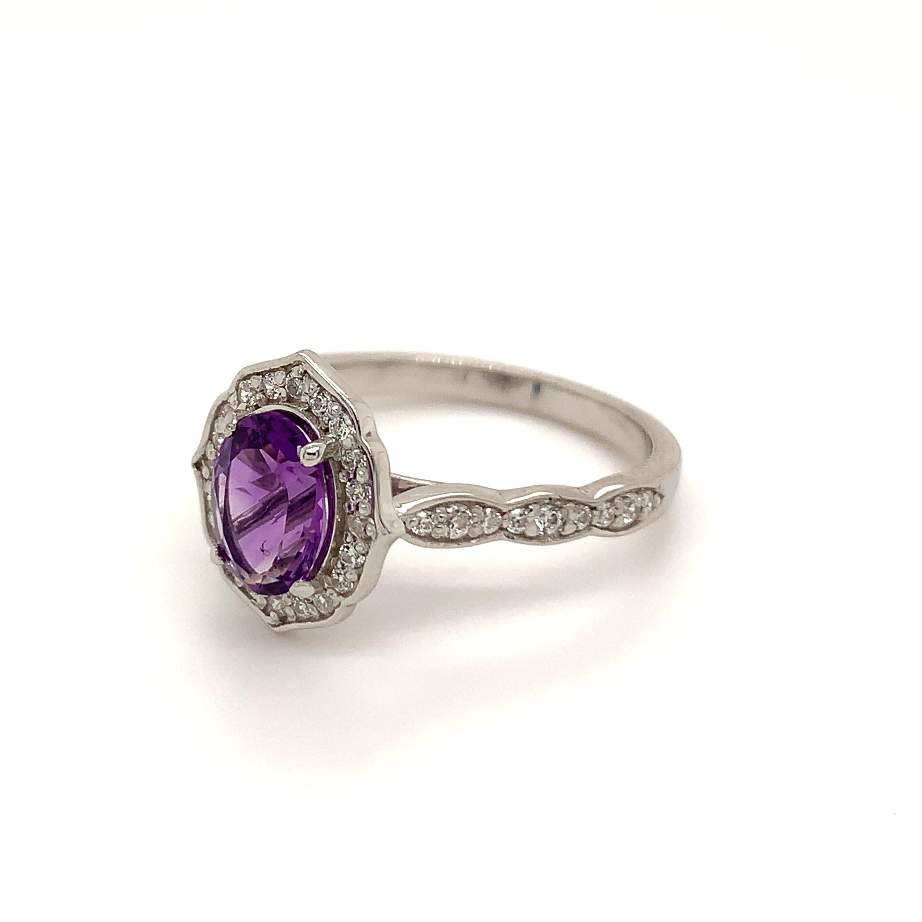 Oval Shape Amethyst Gemstone beautifully crafted with CZ in a Ring. A fiery Violet Color February Birthstone. For a special occasion like Engagement or Proposal or may be as a gift for a special person.
