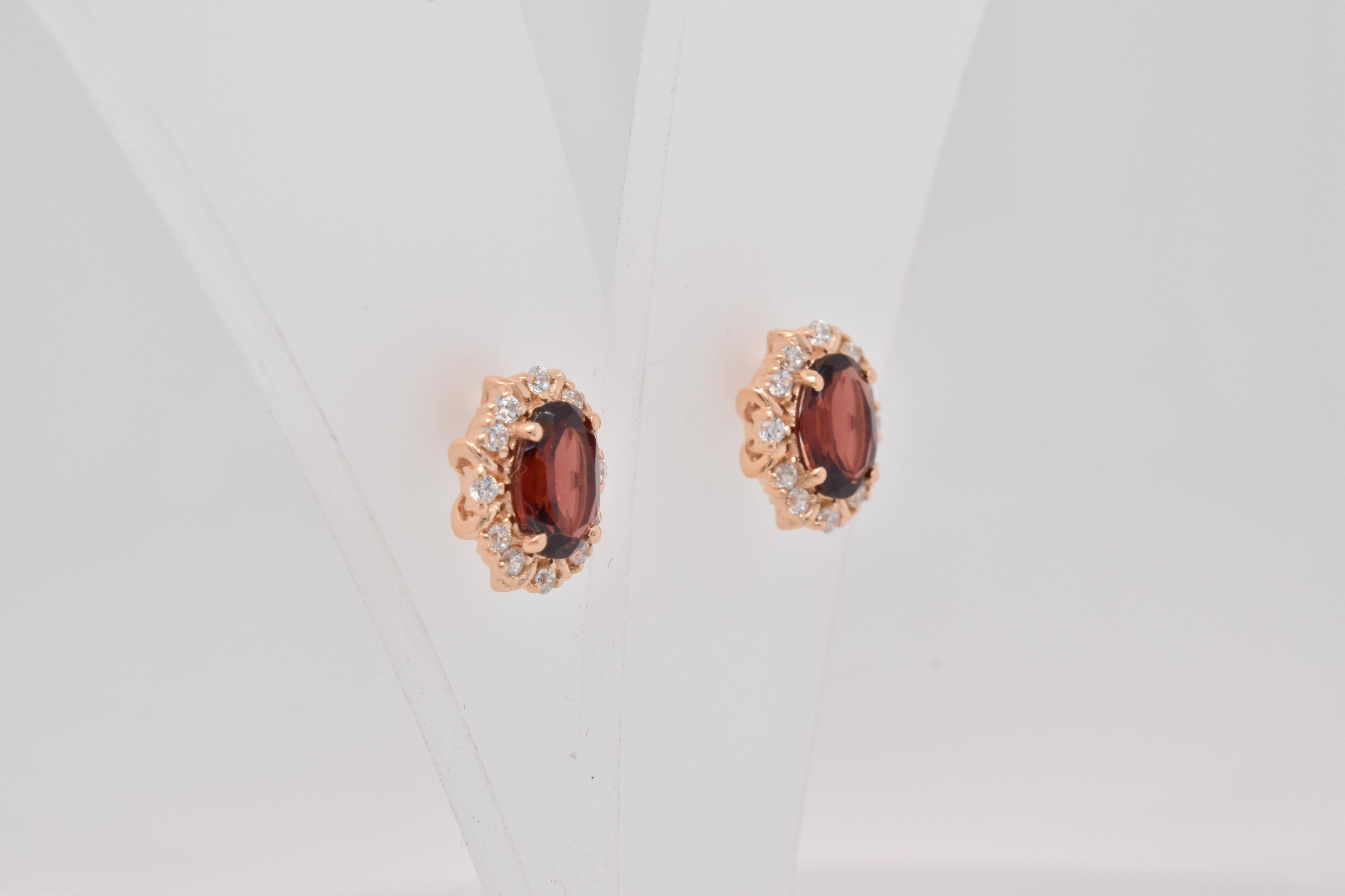 Oval Shape Garnet Gemstone And CZ beautifully crafted  in a Earrings. A fiery Red Color January Birthstone. For a special occasion like Engagement or Proposal or may be as a gift for a special person.

Primary Stone Size - 7x5 mm