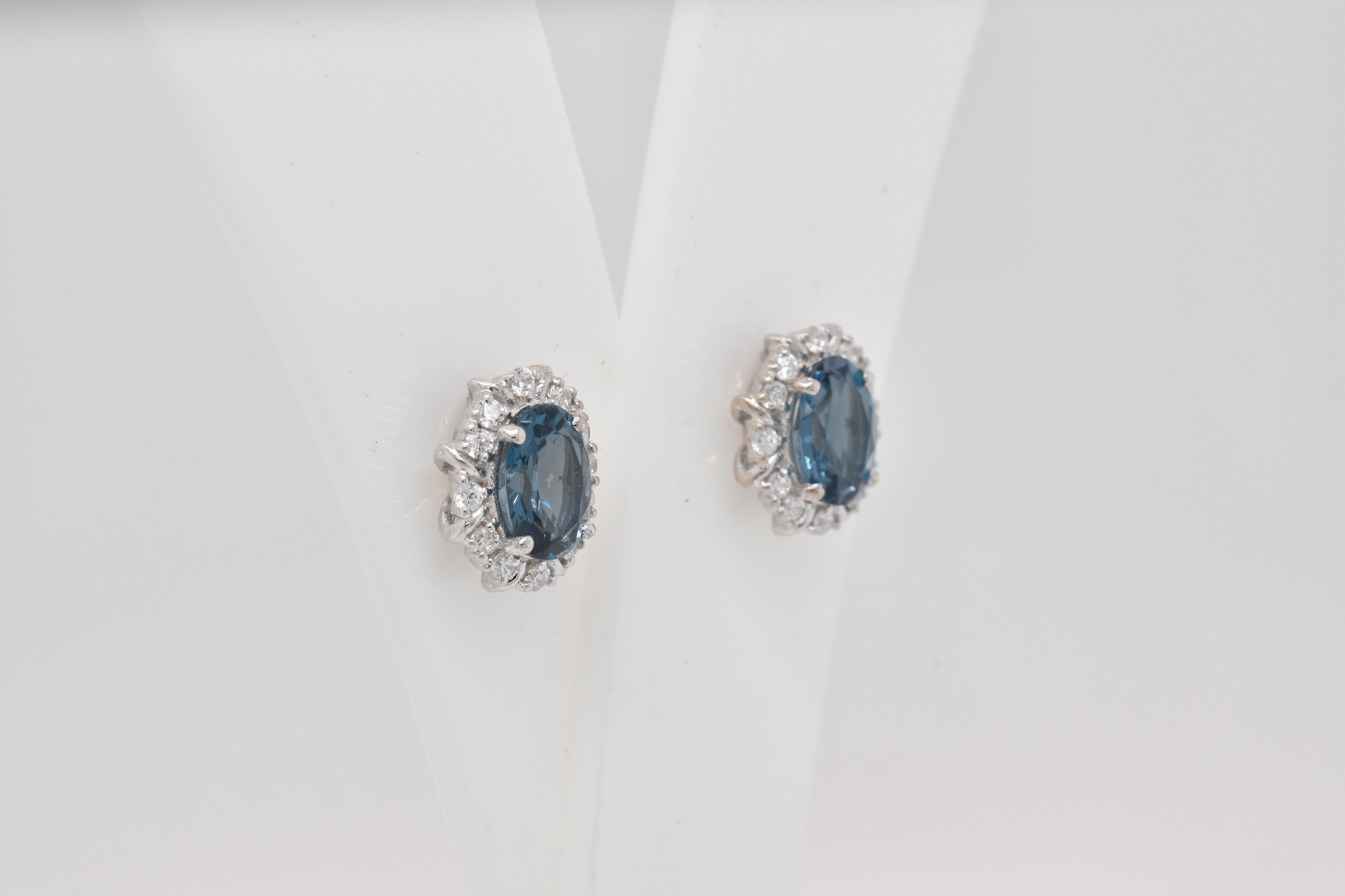 Oval Shape London Blue Topaz Gemstone And CZ beautifully crafted  in a Earrings. A fiery Blue color December Birthstone. For a special occasion like Engagement or Proposal or may be as a gift for a special person.

Primary Stone Size - 7x5 mm
