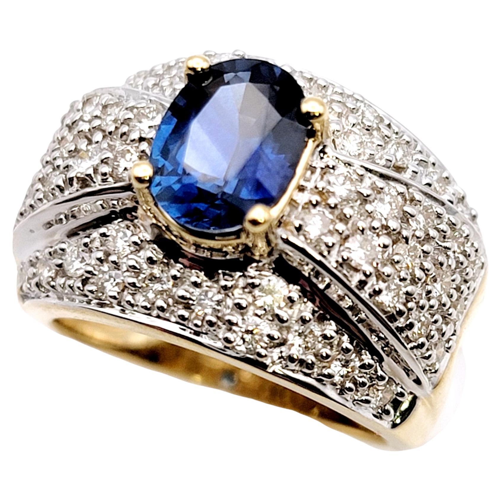 Ring size: 5

Stunningly sparkly wide diamond band ring with a single breathtaking sapphire stone at the center. The striking blue color of the incredible sapphire is enhanced by glittering natural white diamonds that surround it, while the two tone