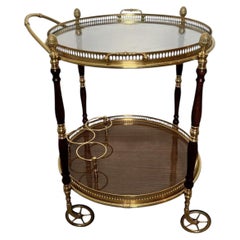Chariot de bar ovale de style néoclassique en laiton et bois, signé Maison Baguès. Circa 1940