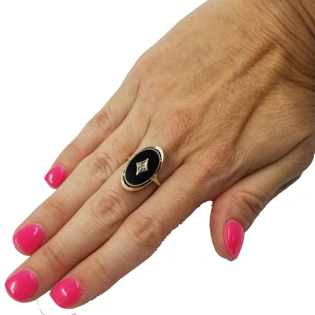 14 Karat Yellow Gold Ring Featuring An Oval Onyx & Small Round Diamond. Finished Weight is 2.7 Grams. Finger Size is Currently 6.75; Purchase Includes One Free Sizing.