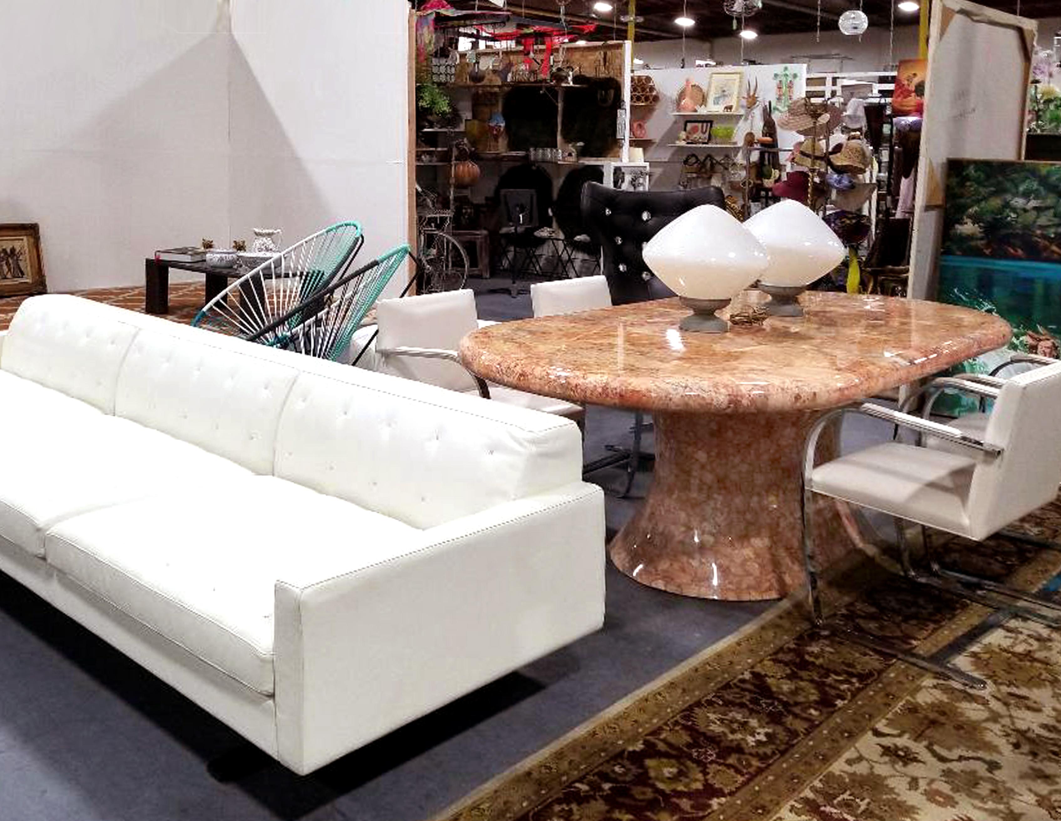 Offered for sale is an oval onyx pedestal dining table by Muller's of Mexico. The rounded edge racetrack top is supported by an hourglass shaped base. The table retains it's original label on the underside as pictured.