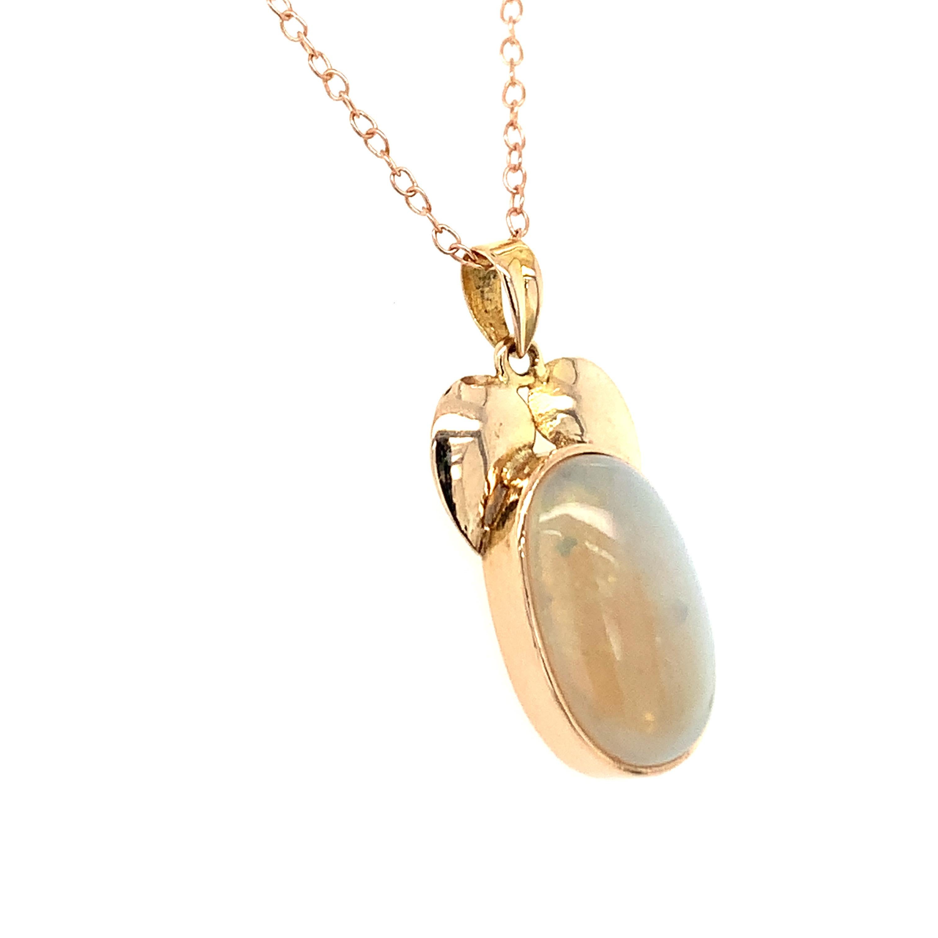 Hand cut and polished natural  Ethiopian Opal is crafted with hand in 14K yellow gold. 
Ideal for daily casual wear.
Chain is not included. 
Image is enlarged for a closer view.
Ethically sourced natural gem stone.