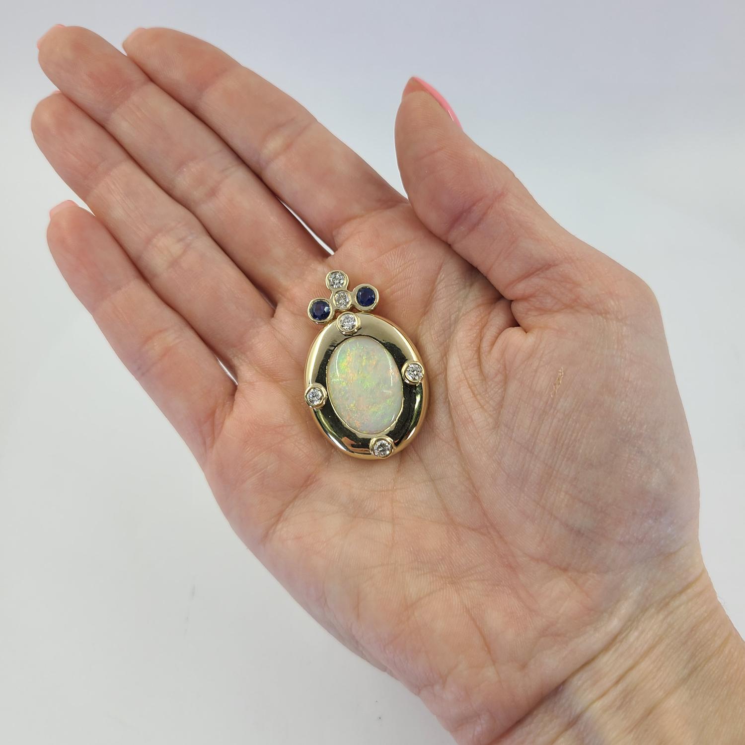 14 Karat Yellow Gold Slide Pendant Featuring A 6 Carat Oval Cabochon Opal with Green, Red, and Yellow Play of Color Measuring Approximately 18mm x 14mm  Accented By 6 Round Diamonds of SI Clarity and H Color Totaling 0.60 Carats and 2 Round