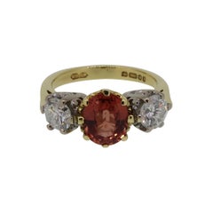 Oval Orange Sapphire and Diamond Three-Stone Ring 18 Karat Yellow and White Gold