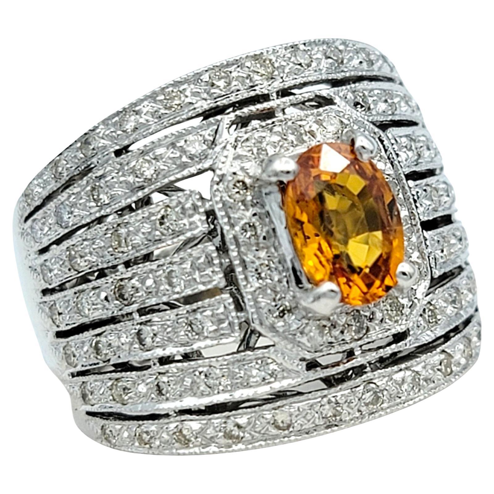Ring Size: 5

This 14 karat white gold ring exudes timeless elegance with its oval orange sapphire centerpiece and 7 surrounding rows of dazzling diamonds. The warm hue of the sapphire contrasts beautifully with the icy brilliance of the diamonds,