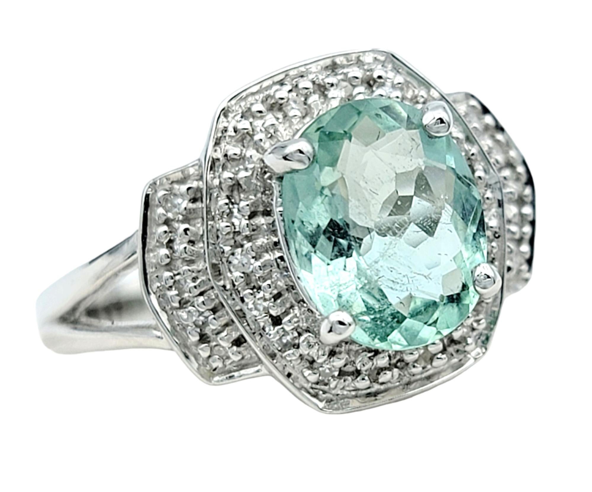 Ring Size: 6.75

Exuding an aura of luxury and refinement, this exquisite ring showcases a captivating oval cut Paraiba tourmaline as its centerpiece. Nestled within a lustrous white gold setting, the vibrant Paraiba tourmaline dazzles with its