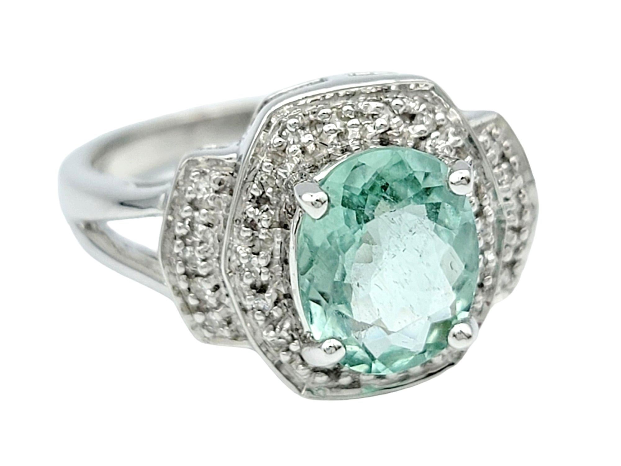 Contemporary Oval Paraiba Tourmaline Ring with Round Diamond Halo Set in 18 Karat White Gold For Sale