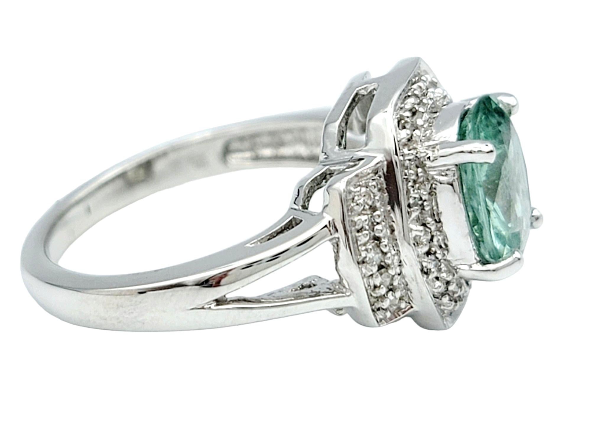 Oval Cut Oval Paraiba Tourmaline Ring with Round Diamond Halo Set in 18 Karat White Gold For Sale