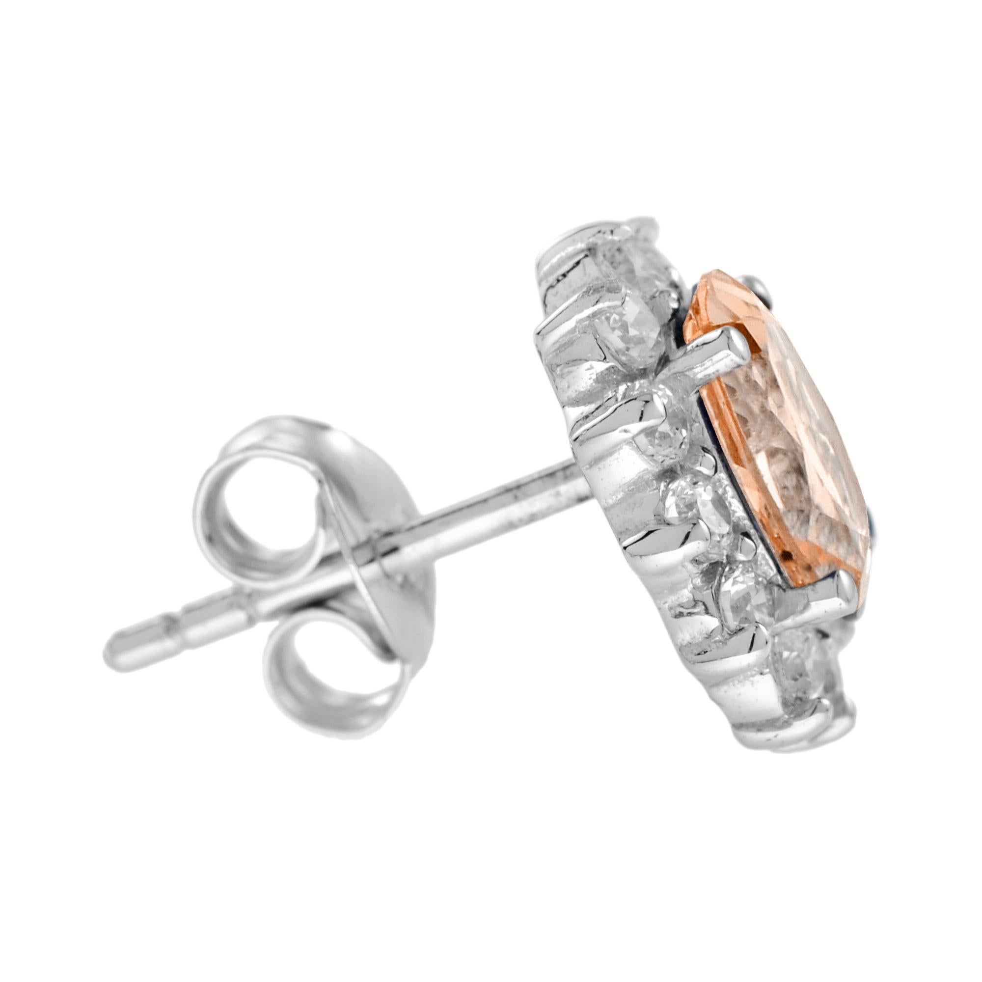 A pair of oval morganite and diamond cluster earrings, each earring comprising an oval morganite surrounded by twelve round brilliant cut diamonds. 14K White Gold. 
Earring Information
Width: 9 mm.
Length: 11 mm.
Weight: 3.30 g. (approx. in