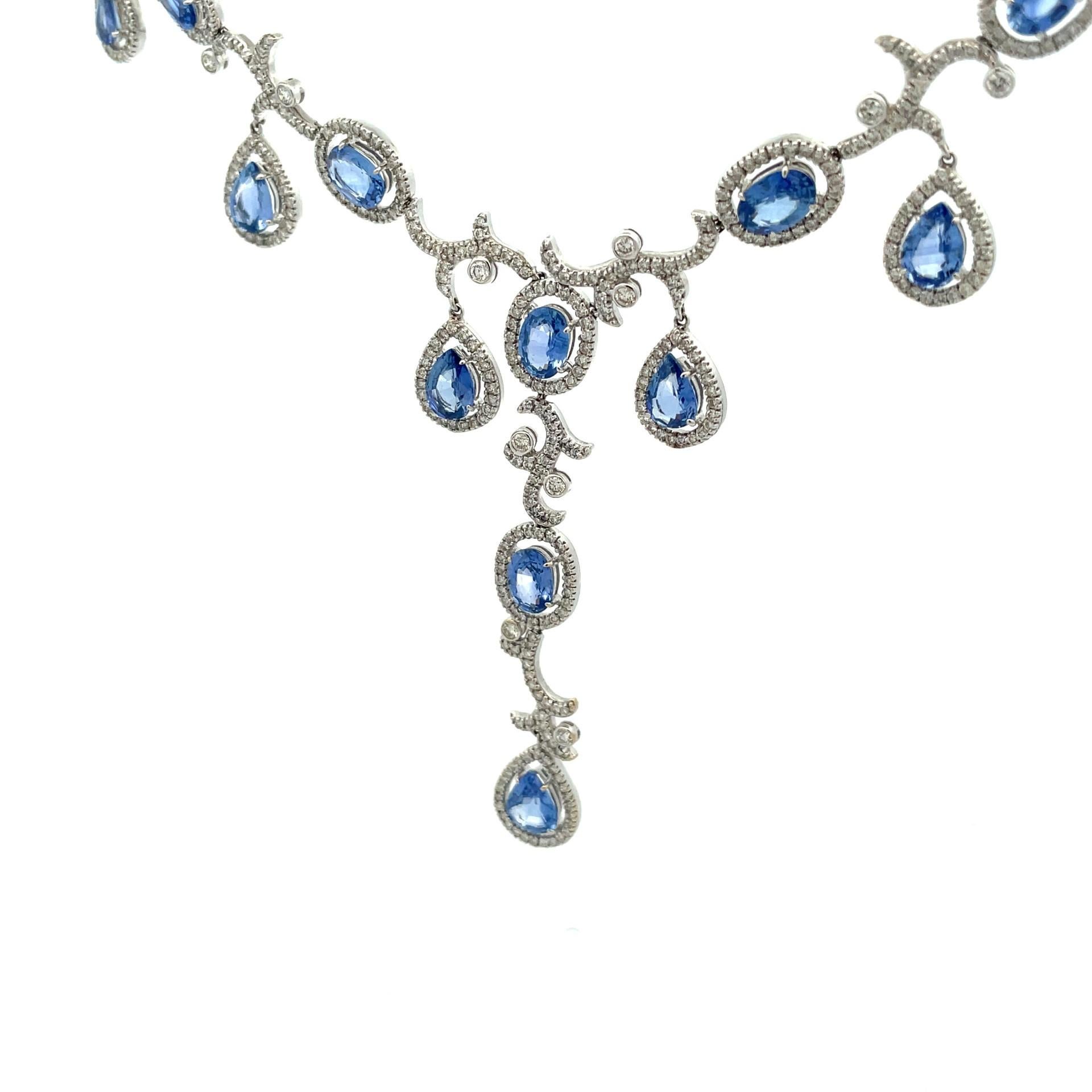 Our sapphire drop necklace in 18kt white gold is designed with a delicate cascade of oval and pear shape natural Ceylon blue sapphires and pave diamond halo set to frame for an elegant evening look.

844 brilliant cut natural white diamonds 5.94ct