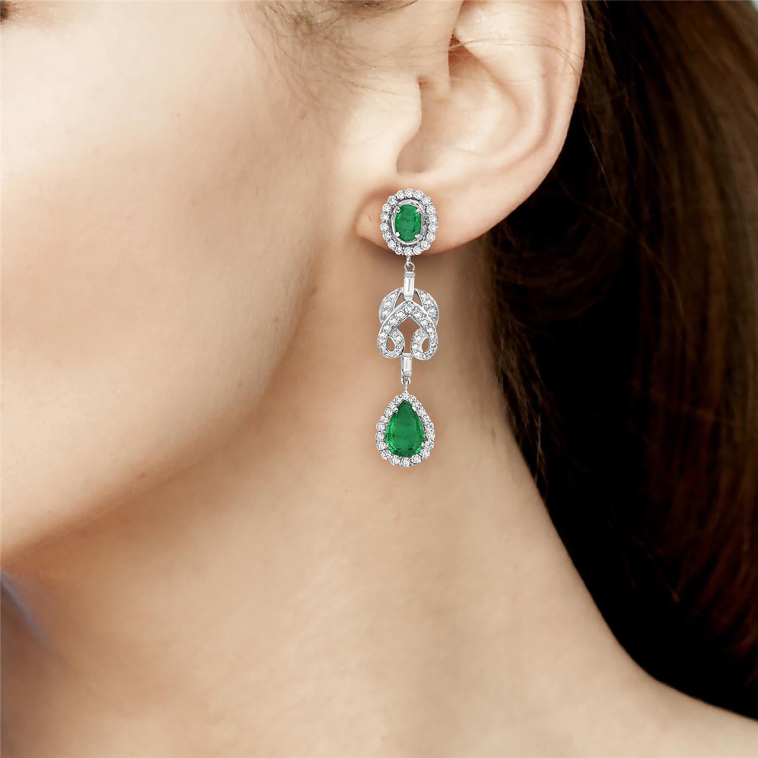 Experience timeless elegance with our 18k white gold Oval & Pear Shaped Emerald Earrings. These stunning earrings feature a beautiful knot shape design, embellished with pave diamonds. The perfect blend of classic and modern, these earrings are sure