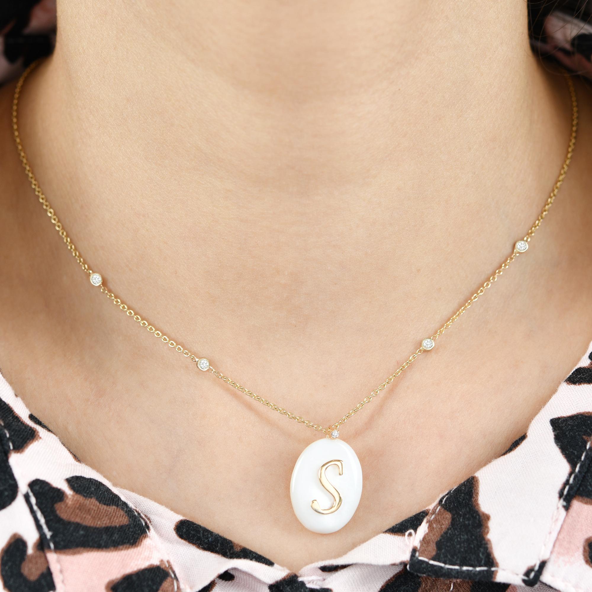 Introducing the elegant Oval Pearl Gemstone Initial S Charm Pendant in 18 Karat Yellow Gold with Diamond accents, a timeless and personalized piece of fine jewelry that combines the beauty of pearls, the luxury of yellow gold, and the sparkle of