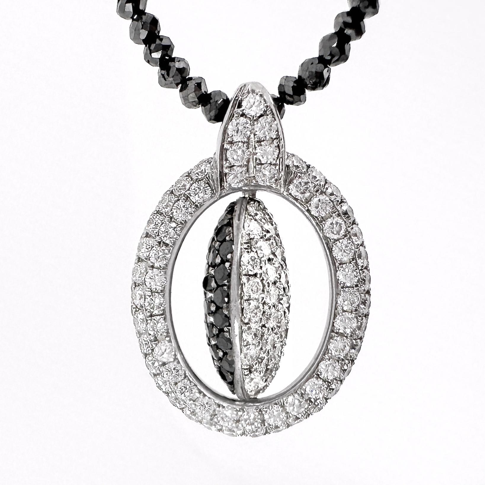 Contemporary Oval Pendant with Reversible Black & White Diamond Center on Black Diamond Chain For Sale