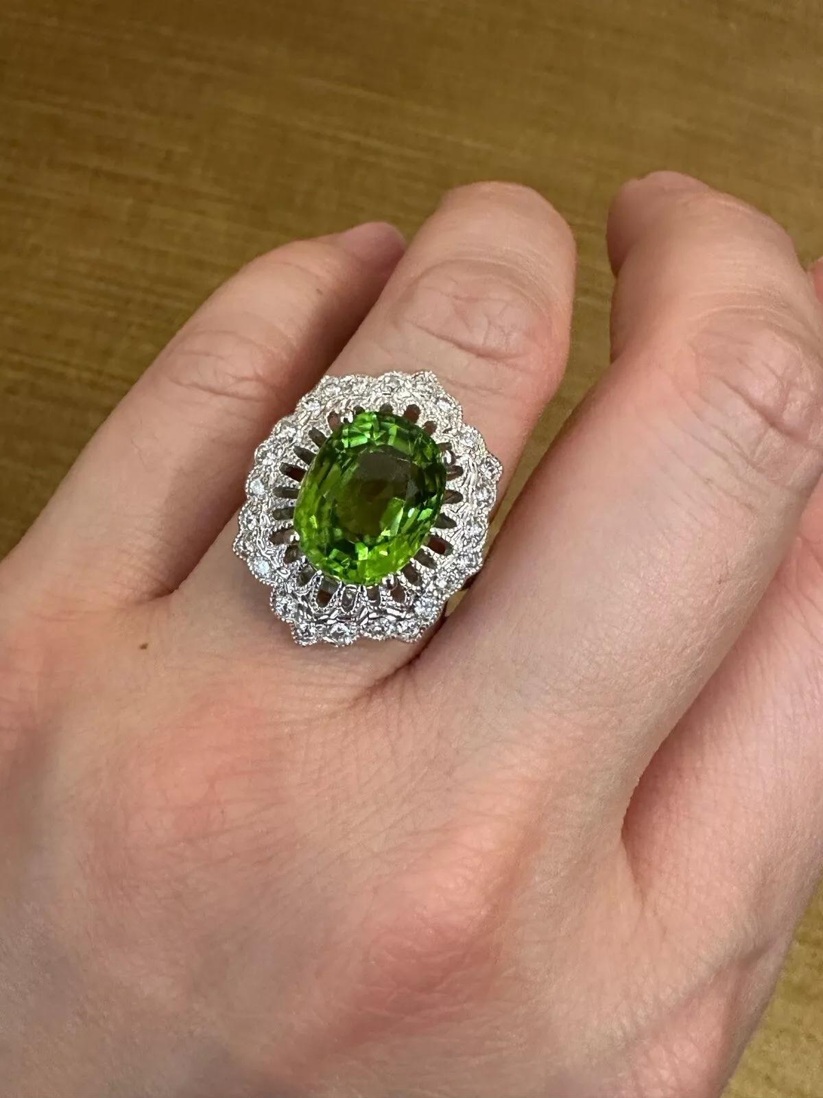 Oval Peridot 7.39 carat and Diamond Cocktail Ring in Platinum 

Peridot and Diamond Ring features a natural Oval faceted Peridot weighing 7.39 carats surrounded by natural Round Brilliant Diamonds, all set in a detailed Platinum setting with