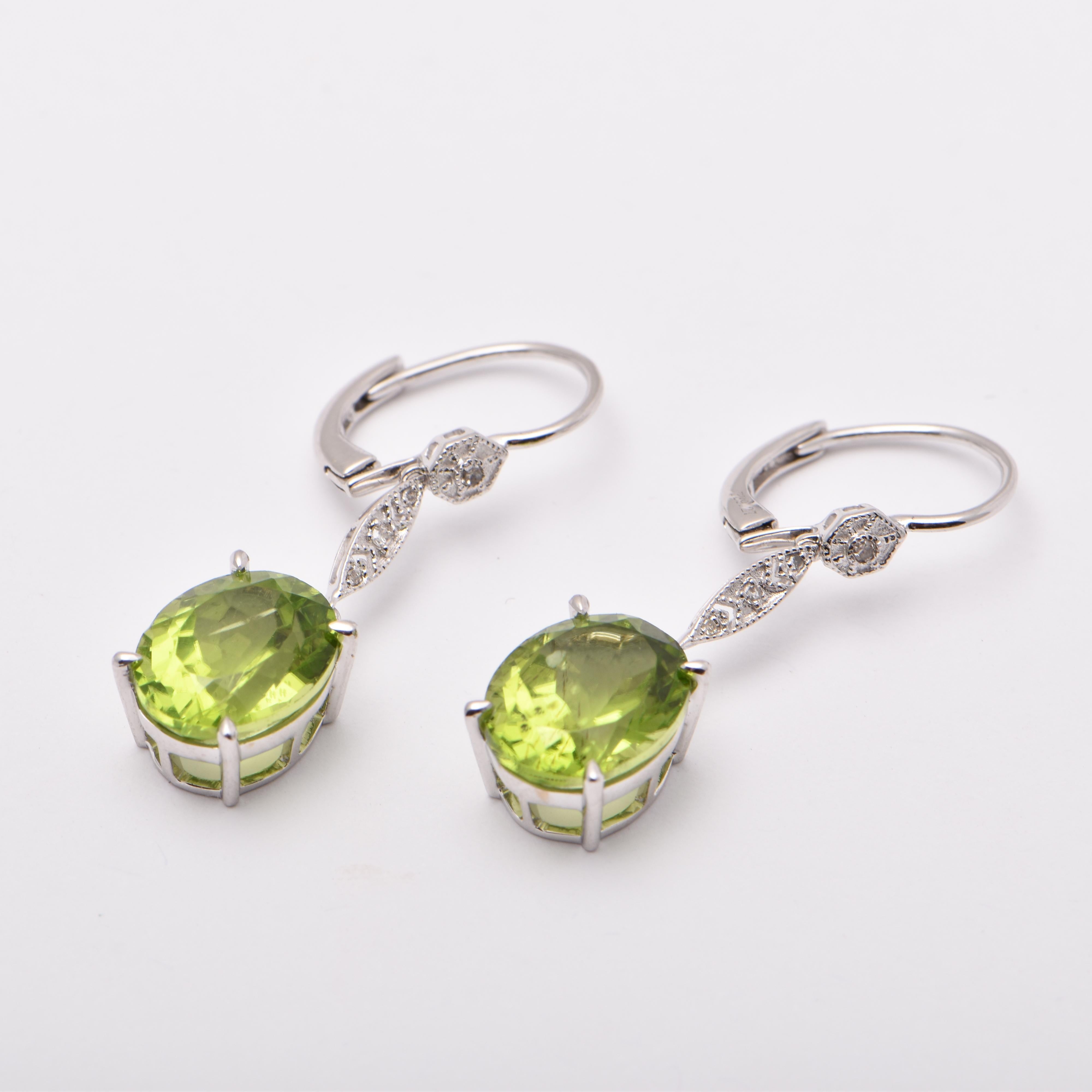 Oval Peridot and Diamond Drop Earrings in 18 Carat White Gold by Cartmer Jewellery  

2 Oval Peridots totalling 9.27 carats
8 Diamonds totalling 0.06 carats  

FREE express postage usually 3-4 days Sydney to New York 
FREE international insurance 