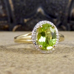 Oval Peridot and Diamond Illusion Halo Cluster Ring in White and Yellow Gold