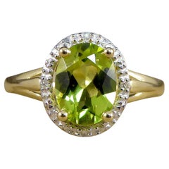 Oval Peridot and Diamond Illusion Halo Cluster Ring in White and Yellow Gold