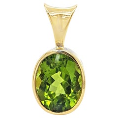 Oval Peridot Pendant Set in Yellow Gold Bezel