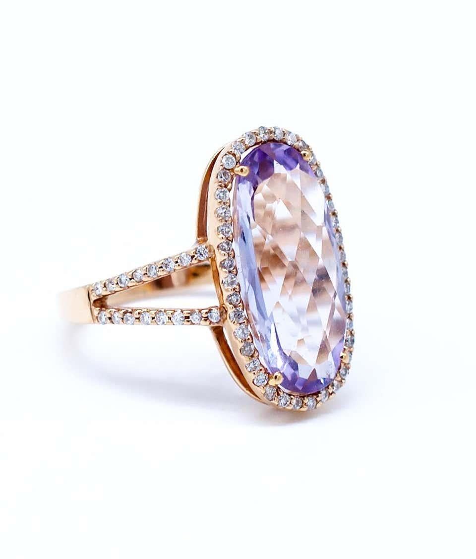 Tapestry cut Kunzite gemstone is set in a beautiful Halo Diamond Ring
Soft colored pinkish purple Kunzite gemstone is oval shaped and has a  weight of 4.88 carats.
The cut is tapestry with faceting on the table making the stone reflect light and
