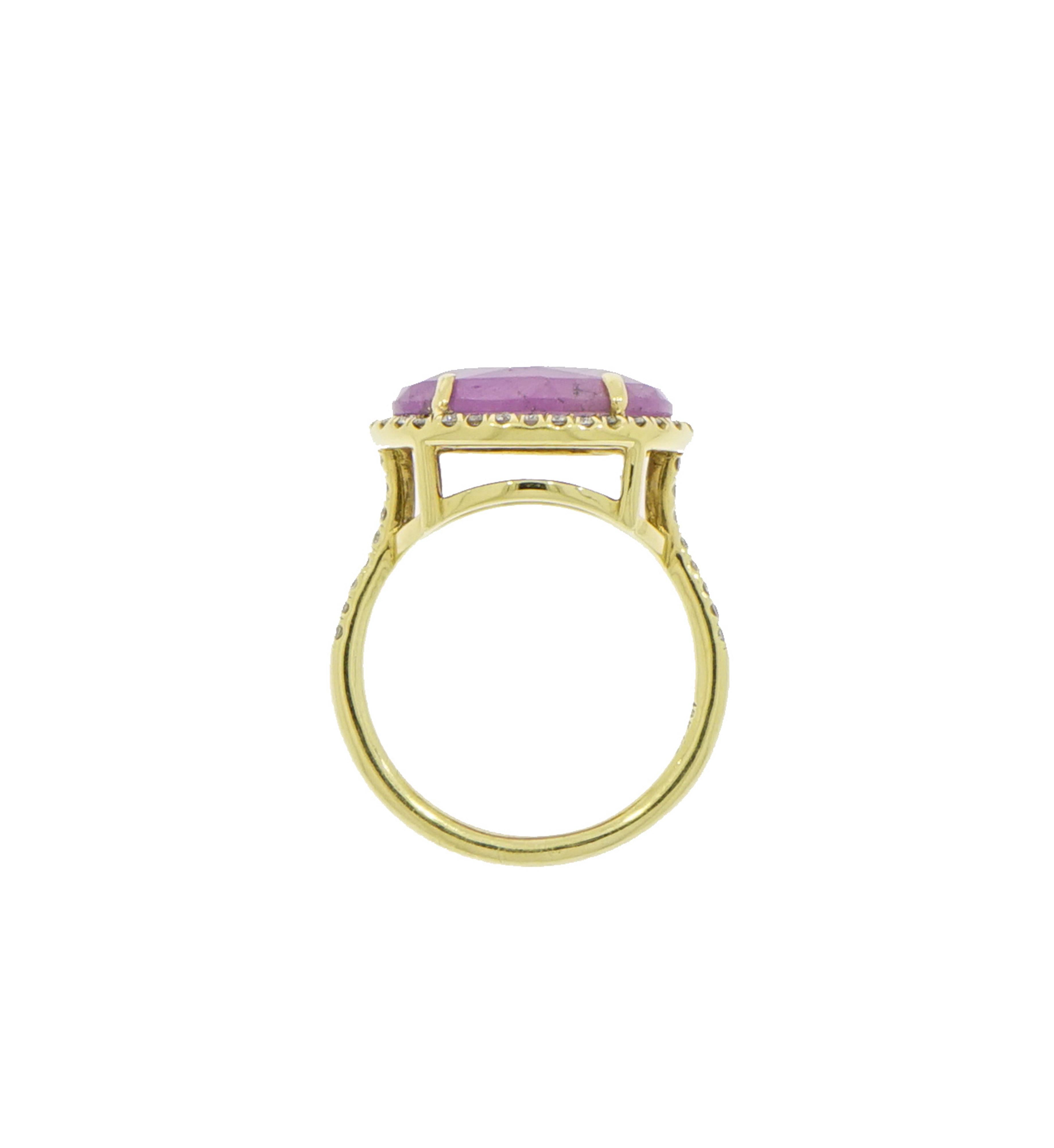 Fluid shapes, sculptural designs, bright gems, yellow gold and diamonds are combined to create the most beautiful rings. 
Designed and crafted in NYC this gorgeous oval shaped with a purplish hue Pink Sapphire is set east west in a yellow gold ring