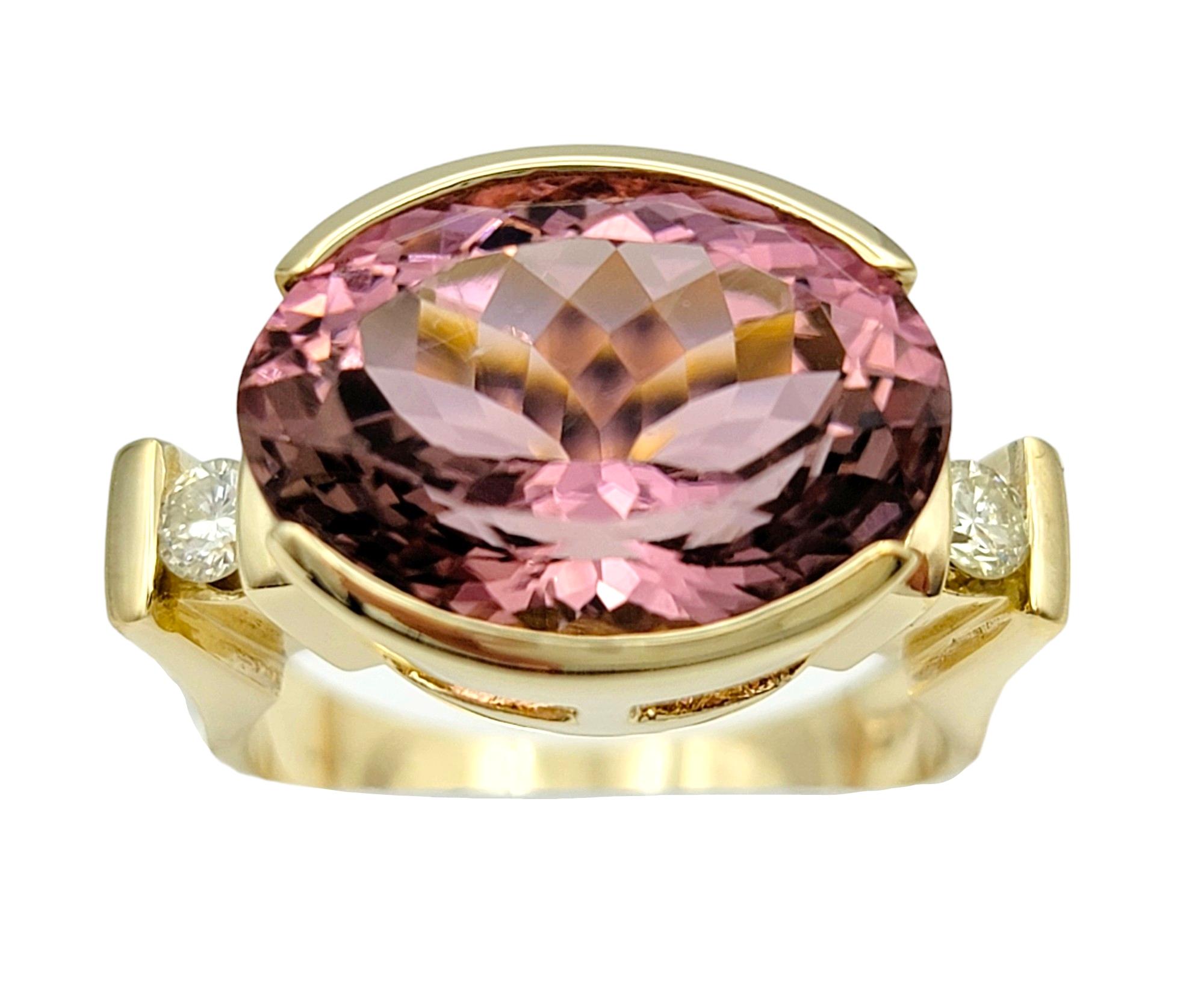 Ring Size: 6.75

This exquisite oval pink tourmaline cocktail ring, set in 14 karat yellow gold, is a stunning ring that features a distinctive east-west setting. The vibrant oval pink tourmaline at the center is flanked by sparkling diamonds on