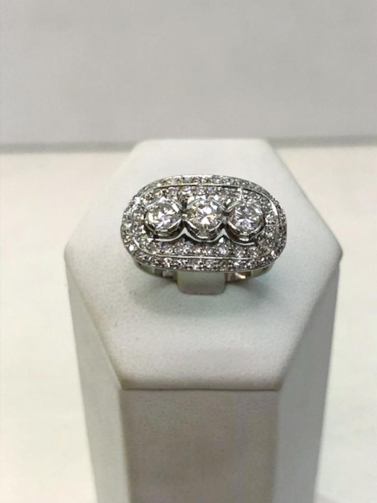 Oval shaped platinum ring with 3 central diamonds for a total of 0.75 carats, and surrounding diamonds for a total of 0.50 carats / Made in Italy 1950s-1960s
Ring size US 6.5