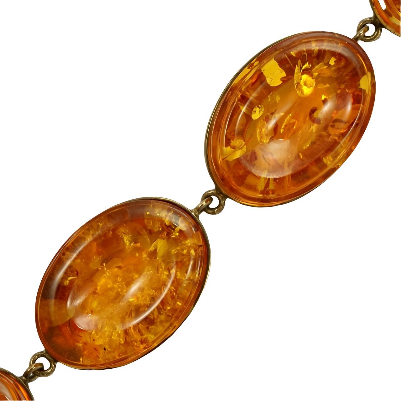 Beautiful gold vermeil on sterling silver link bracelet, set with oval amber stones.

The bracelet is stamped with a lion, a leopard's head and the The Millennium mark which is the number 2000 within a square cross. This means that the bracelet is