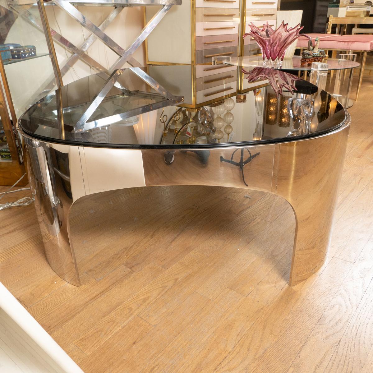 Oval polished stainless steel and black glass coffee table by Brueton. 