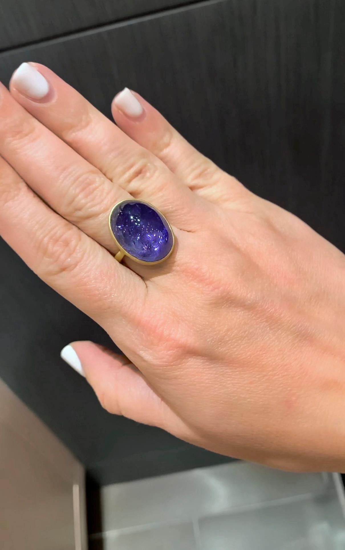 One of a Kind Dome Ring hand-fabricated by jewelry maker Lola Brooks showcasing a magnificent 28.83 carat deep purple blue oval tanzanite cabochon, bezel-set and framed in the artist's signature-finished 18k yellow gold. Size 6.5. Stamped and