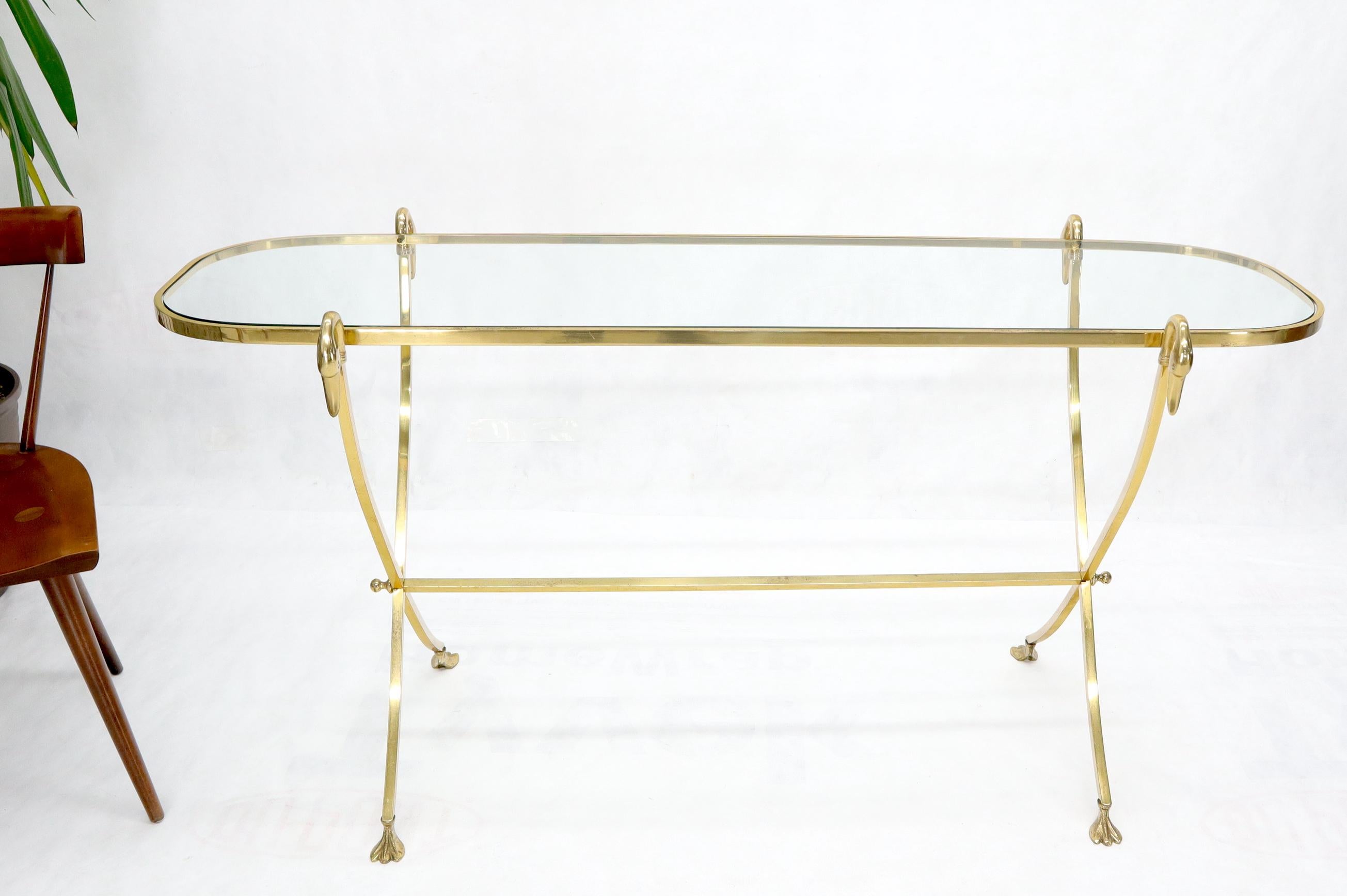 Stunning solid brass glass top console table with swan heads finials on X-base.