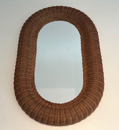 Oval rattan mirror. French work. Circa 1970