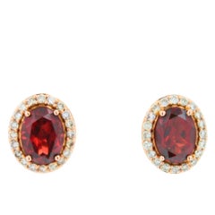 Orecchini ovali in oro rosa 18 carati con granato rosso e diamante a raggiera
