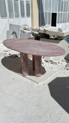 Oval Red Travertine Dining Table with Column Legs in the style of Mario Bellini