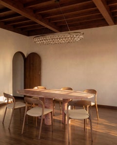 Oval Red Travertine Dining Table with Column Legs in the style of Mario Bellini