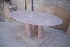 Oval Red Travertine Dining Table with Column Legs in the style of Mario Bellini