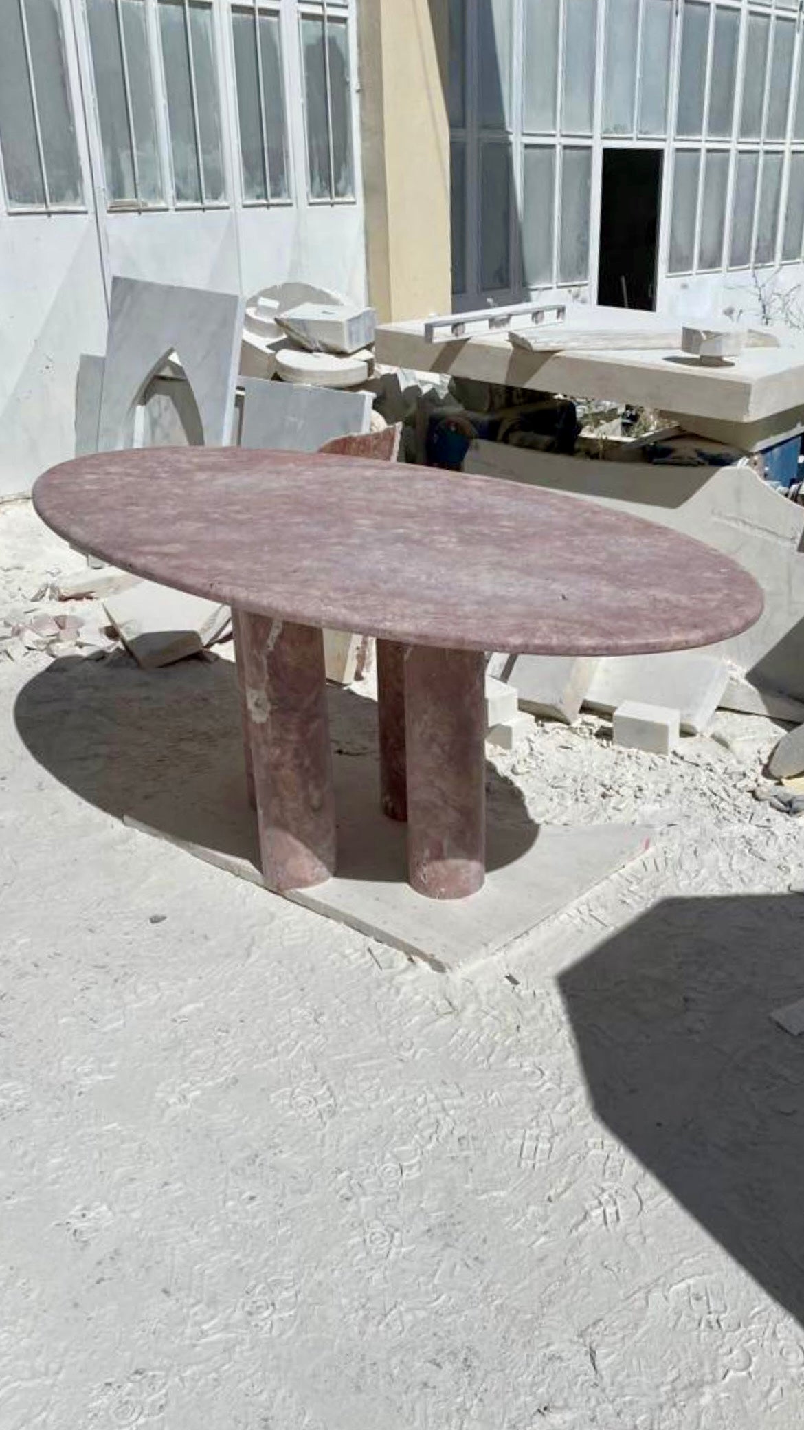 Oval Red Travertine Dining Table with Column Legs in the style of Mario Bellini  For Sale
