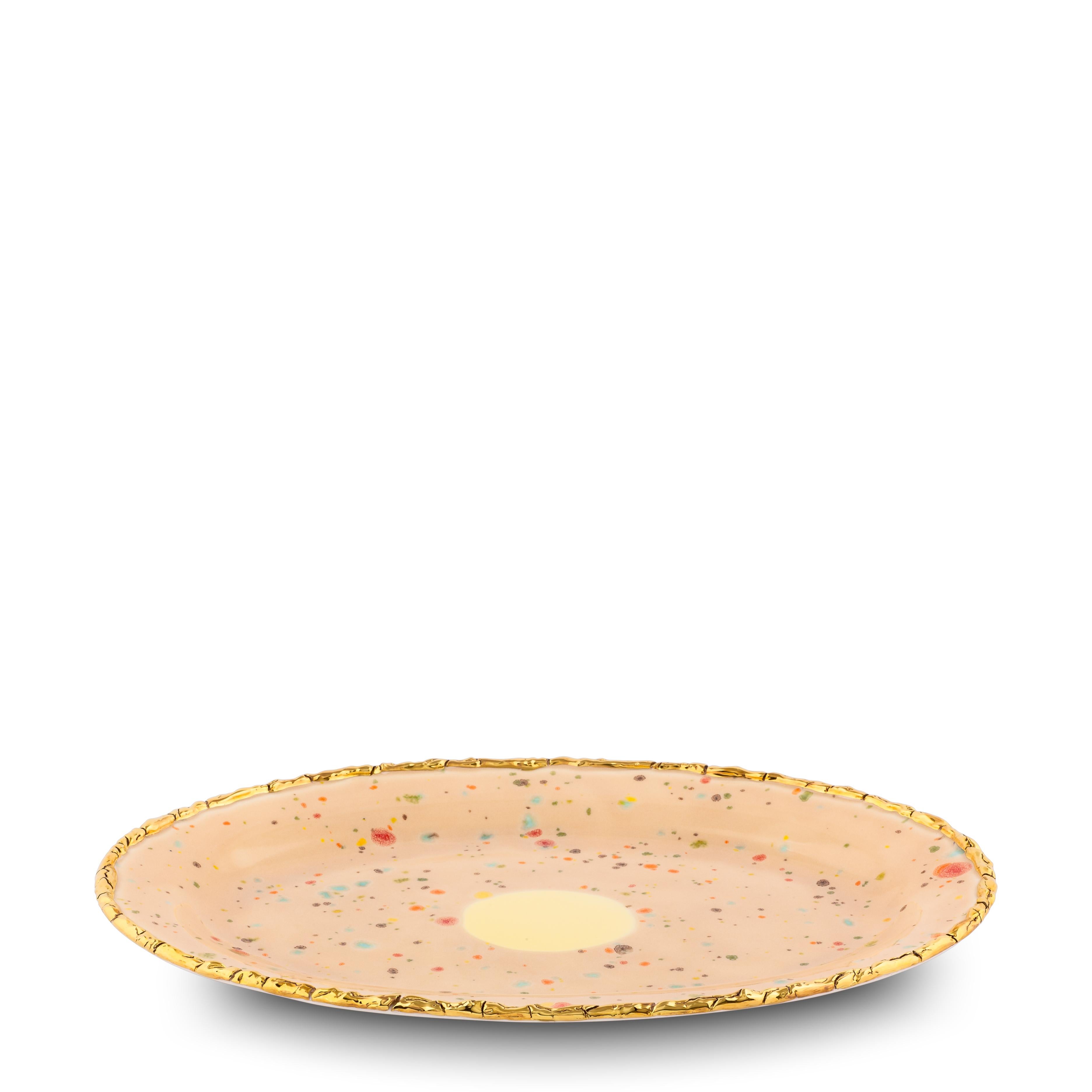 Handcrafted in Italy from the finest porcelain, this Craquelé edge oval rim platter from the Chestnut Collection has a unique golden crackled rim emphasizing the warm sandy surface covered with little multicolor dots and the bright yellow splotch at