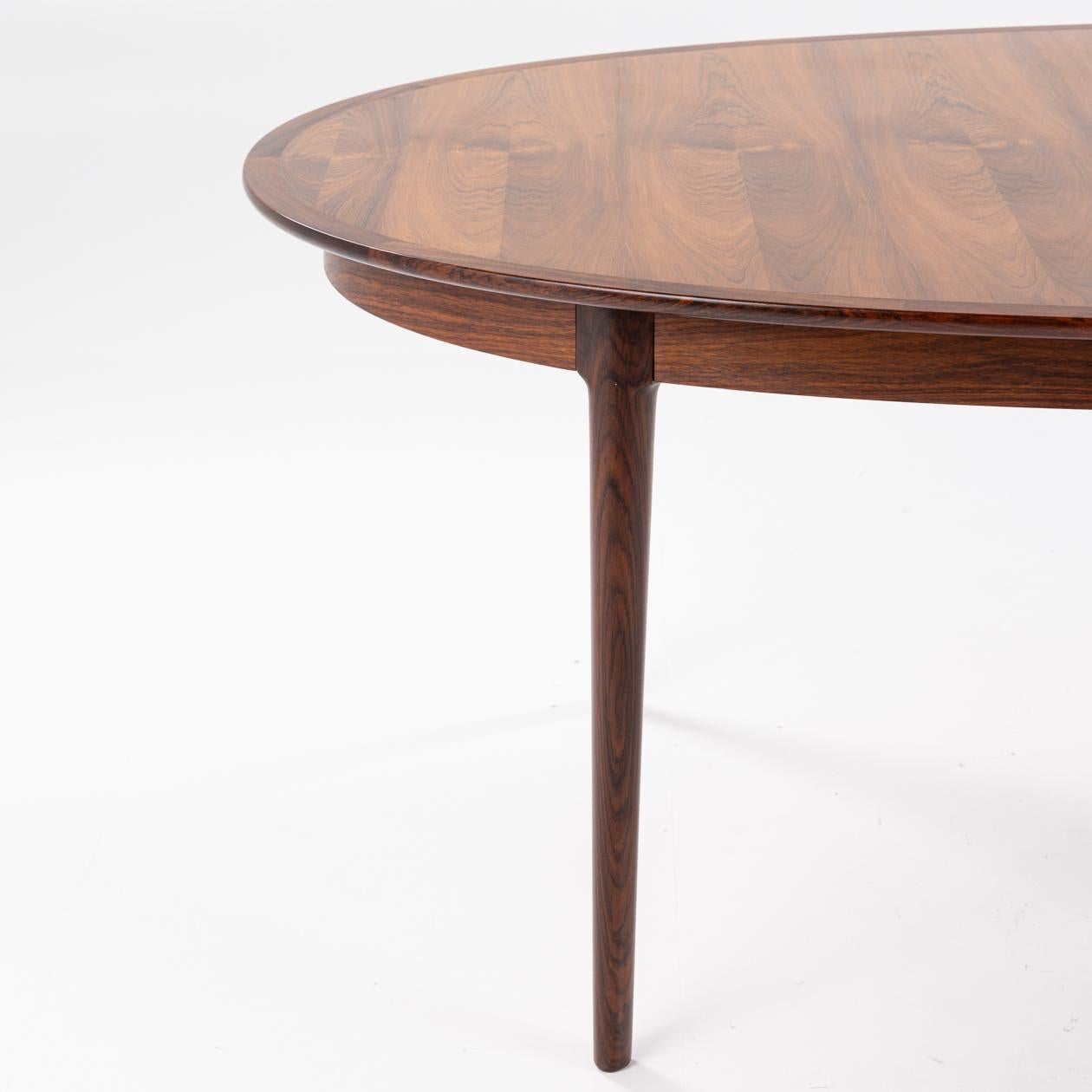 Oval rosewood dining table with two extension leaves. Original brand from manufacturer. Two plates of 50 cm. Torbjørn Afdal / Bruksbo