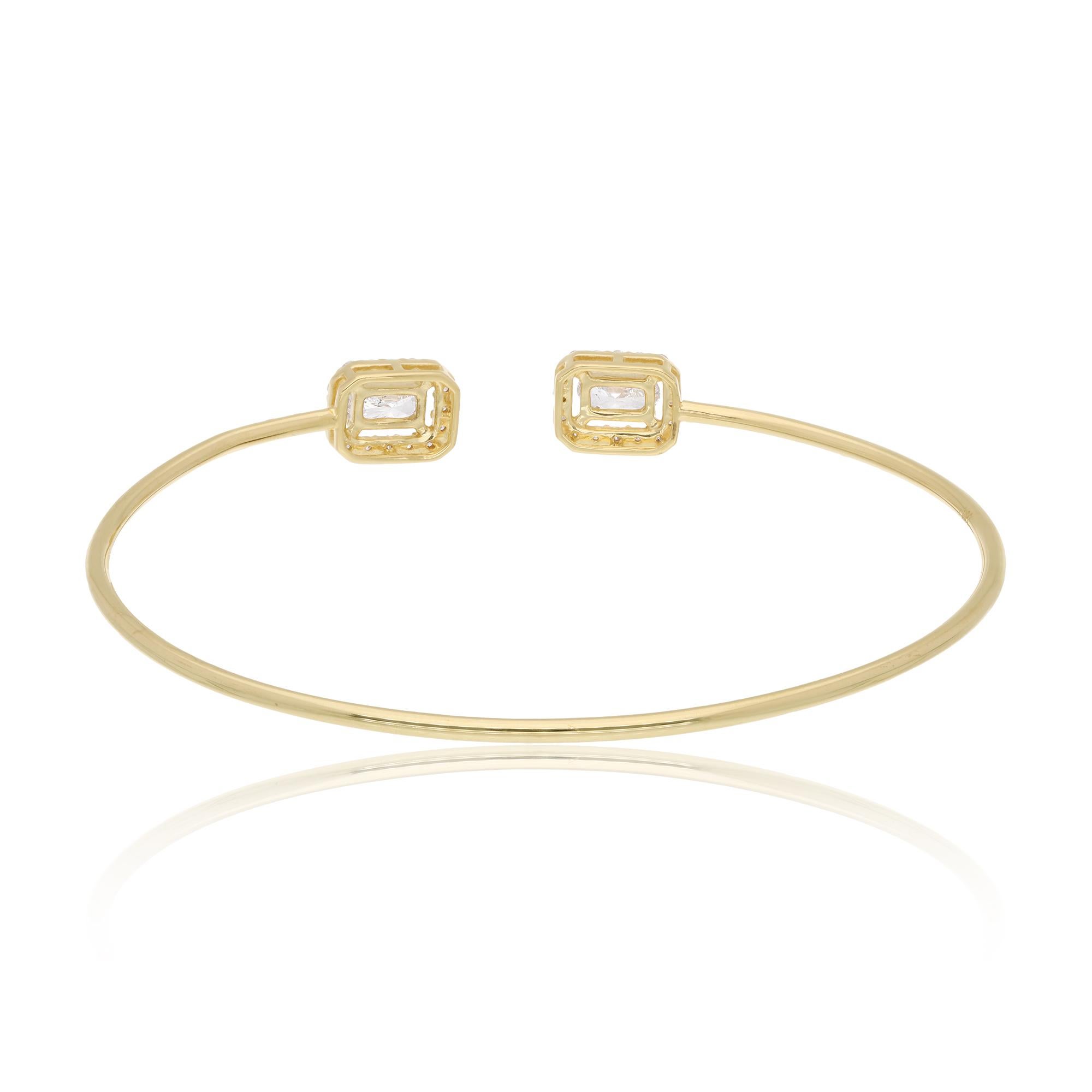 The bracelet features a sleek and modern design, with a cuff style that effortlessly wraps around the wrist, offering a comfortable and secure fit. Its smooth, polished surface glimmers with the warm glow of 14 karat yellow gold, adding a touch of
